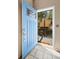 Light-blue entry door opens to reveal a charming, elevated treehouse visible from the doorway at 8386 S Davco Dr, Morrison, CO 80465