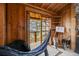 Cozy interior space showcasing wood walls, an outdoor balcony, and unique artistic displays at 8386 S Davco Dr, Morrison, CO 80465