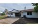 Well-maintained back exterior featuring a brick patio and black trim at 10297 W Crestone Mtn, Littleton, CO 80127