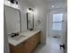Modern bathroom featuring double sinks, quartz countertops, and neutral finishes at 10297 W Crestone Mtn, Littleton, CO 80127