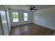 Well-lit bedroom with hardwood floors, ceiling fan, and view of the lawn at 10297 W Crestone Mtn, Littleton, CO 80127