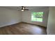 Bedroom featuring hardwood floors, ceiling fan, and a large window with green lawn at 10297 W Crestone Mtn, Littleton, CO 80127