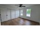 Bright bedroom with hardwood floors, ceiling fan, and a closet at 10297 W Crestone Mtn, Littleton, CO 80127