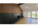 Stylish fireplace featuring unique dark tile and wood paneling at 10297 W Crestone Mtn, Littleton, CO 80127