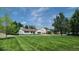 Expansive front yard featuring a well-maintained lawn and inviting curb appeal at 10297 W Crestone Mtn, Littleton, CO 80127