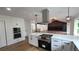 Modern kitchen with stainless appliances, a large island, and pendant lighting at 10297 W Crestone Mtn, Littleton, CO 80127