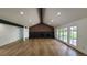 Spacious living room with fireplace, wood accent wall, and light wood flooring at 10297 W Crestone Mtn, Littleton, CO 80127