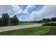 Picturesque street view showcasing green lawns and beautiful trees at 10297 W Crestone Mtn, Littleton, CO 80127