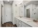 Bathroom featuring double vanity with white cabinets, stone countertops and modern fixtures at 485 Interlocken Blvd # 209, Broomfield, CO 80021