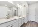 Modern bathroom with double vanity, quartz countertop, and glass-enclosed shower at 485 Interlocken Blvd # 209, Broomfield, CO 80021