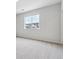 Bright bedroom with a large window and neutral carpet at 485 Interlocken Blvd # 209, Broomfield, CO 80021
