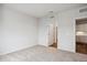 Bedroom with neutral carpet, adjacent door opening into kitchen area at 485 Interlocken Blvd # 209, Broomfield, CO 80021