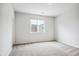 Bright bedroom features neutral carpet, natural light from a window with neighborhood views at 485 Interlocken Blvd # 209, Broomfield, CO 80021