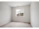 Bright bedroom featuring neutral carpet, natural light from window with neighborhood views at 485 Interlocken Blvd # 209, Broomfield, CO 80021