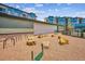 Outdoor dog park featuring agility equipment and gravel ground, surrounded by condos at 485 Interlocken Blvd # 209, Broomfield, CO 80021