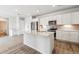 Spacious modern kitchen with white cabinets, stainless appliances, and a large kitchen island at 485 Interlocken Blvd # 209, Broomfield, CO 80021