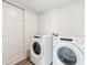 Bright laundry room features white washer and dryer set, as well as white sliding doors at 485 Interlocken Blvd # 209, Broomfield, CO 80021