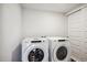 Laundry room with white appliances and closet space at 485 Interlocken Blvd # 209, Broomfield, CO 80021