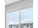 A window that provides natural light and views of nearby houses at 485 Interlocken Blvd # 209, Broomfield, CO 80021