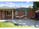 Cozy backyard patio with a brick exterior, features a comfortable hammock and a well-maintained grassy area at 2649 N Cook St, Denver, CO 80205