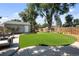 Well-maintained backyard featuring artificial turf, a detached flex space, and a privacy fence for added seclusion at 2649 N Cook St, Denver, CO 80205