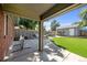 Covered patio overlooking a landscaped backyard with artificial grass and additional seating area for outdoor entertaining at 2649 N Cook St, Denver, CO 80205