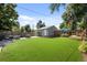 Landscaped backyard featuring artificial turf and a detached flex space, perfect for outdoor activities and relaxation at 2649 N Cook St, Denver, CO 80205