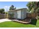 Backyard featuring a detached flex space or shed, complemented by artificial turf for low maintenance and enjoyment at 2649 N Cook St, Denver, CO 80205