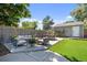 Charming backyard showcasing a spacious patio with ample seating and dining space, surrounded by lush greenery at 2649 N Cook St, Denver, CO 80205