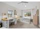 Comfortable bedroom with ample natural light, complemented by a dedicated workspace and tasteful decor at 2649 N Cook St, Denver, CO 80205