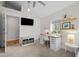 Cozy bedroom with a dedicated workspace, featuring a built-in desk, TV and bench for relaxation at 2649 N Cook St, Denver, CO 80205