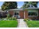 Cozy seating area with flowers adorning this brick home's front porch at 2649 N Cook St, Denver, CO 80205