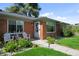 Inviting front porch featuring cozy seating, enhancing the curb appeal of this brick home at 2649 N Cook St, Denver, CO 80205