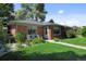 Charming home with a well-manicured front lawn and a cozy, inviting front porch at 2649 N Cook St, Denver, CO 80205