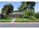 Charming brick home featuring a well-maintained lawn and cozy front porch seating area at 2649 N Cook St, Denver, CO 80205