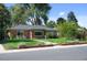 Well-manicured front yard with lush green lawn and mature trees around the house at 2649 N Cook St, Denver, CO 80205