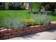 Charming brick planter adorned with colorful flowers enhancing the front yard appeal at 2649 N Cook St, Denver, CO 80205