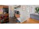 Modern kitchen featuring an island, coffee bar and adjacent laundry area with stainless steel appliances at 2649 N Cook St, Denver, CO 80205