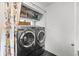 Well-organized laundry room with modern washer and dryer, plus storage shelves at 2649 N Cook St, Denver, CO 80205