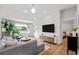 Spacious living room with a cozy sectional, hardwood flooring, and a large window at 2649 N Cook St, Denver, CO 80205
