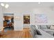 Open-concept design with view from living room to kitchen featuring wood floors and modern decor at 2649 N Cook St, Denver, CO 80205