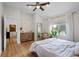 Bright main bedroom featuring hardwood floors, a large window and access to a home office at 2649 N Cook St, Denver, CO 80205