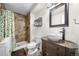 Bathroom featuring tiled shower with a decorative glass door and a unique vessel sink at 1777 Main St, Georgetown, CO 80444