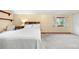 Bright bedroom featuring a comfortable bed, a large window, and neutral carpeting at 1777 Main St, Georgetown, CO 80444