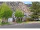 Inviting gray home with solar panels, red door, and a charming front porch at 1777 Main St, Georgetown, CO 80444