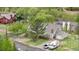 Aerial view of a gray single-Gathering home with solar panels, garage and mature trees at 1777 Main St, Georgetown, CO 80444