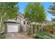 Charming exterior of a gray home with a garage and well-maintained yard with trees at 1777 Main St, Georgetown, CO 80444