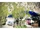 Charming exterior featuring solar panels, well-maintained lawn, aspen trees, and a lovely red front door at 1777 Main St, Georgetown, CO 80444