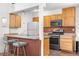 Open concept kitchen features a stainless steel gas range and a breakfast bar at 1777 Main St, Georgetown, CO 80444