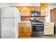 Well-equipped kitchen with wood cabinets, and stainless steel appliances providing ample space at 1777 Main St, Georgetown, CO 80444